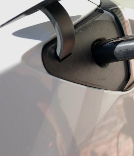EV charging cable plugged into a home charging port